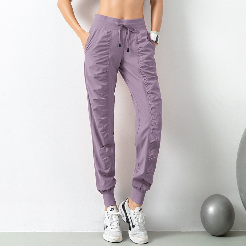Wąskie spodnie dresowe z kieszeniami - Fioletowy / S